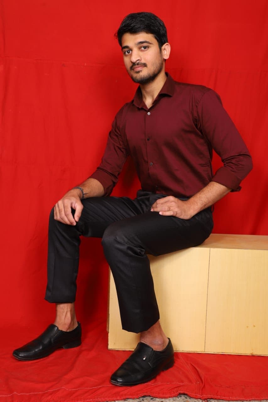 Model seated in black formal trousers